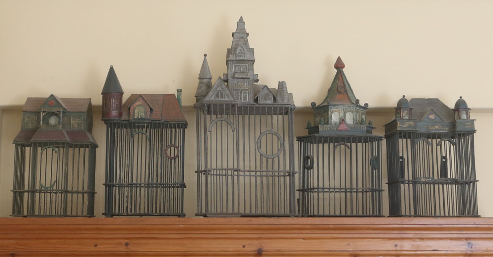Birdcages on glasses cupboard