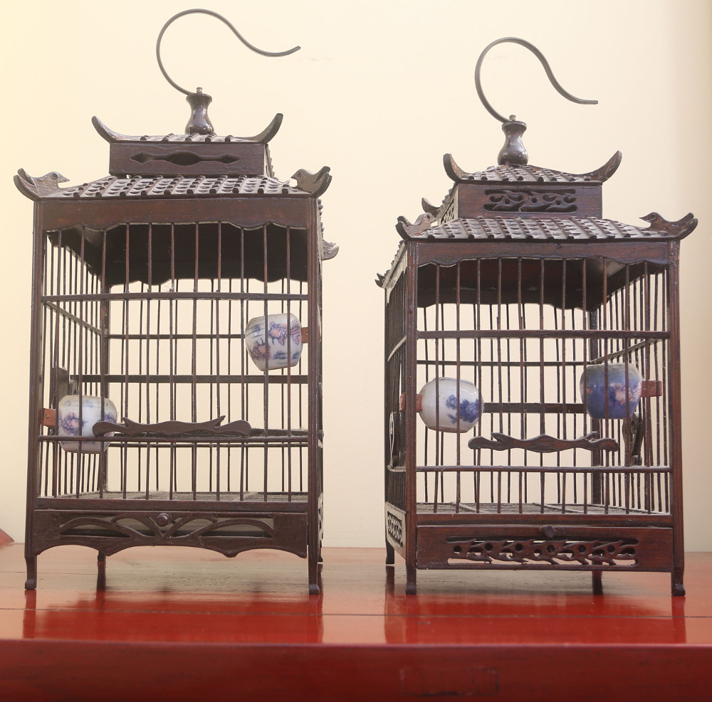 Birdcages on side table with sculpture